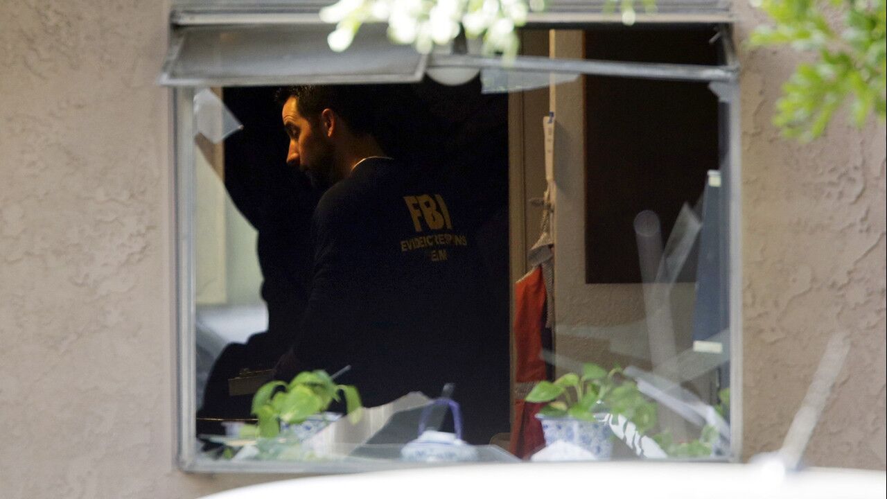 FBI investigators inside the suspects' Redlands home on Thursday morning.