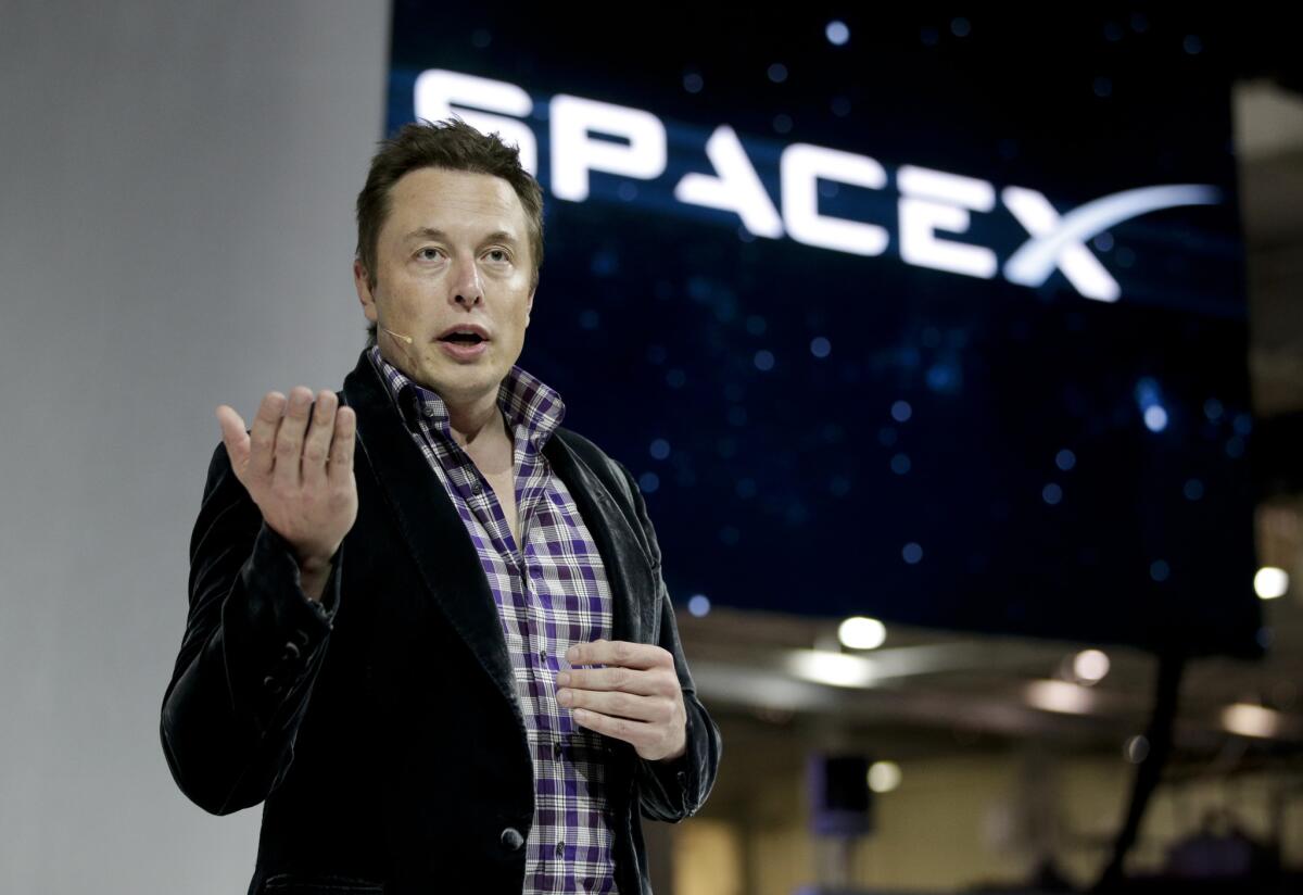 SpaceX CEO Elon Musk introduces the Dragon V2 spaceship at the company's headquarters in Hawthorne.