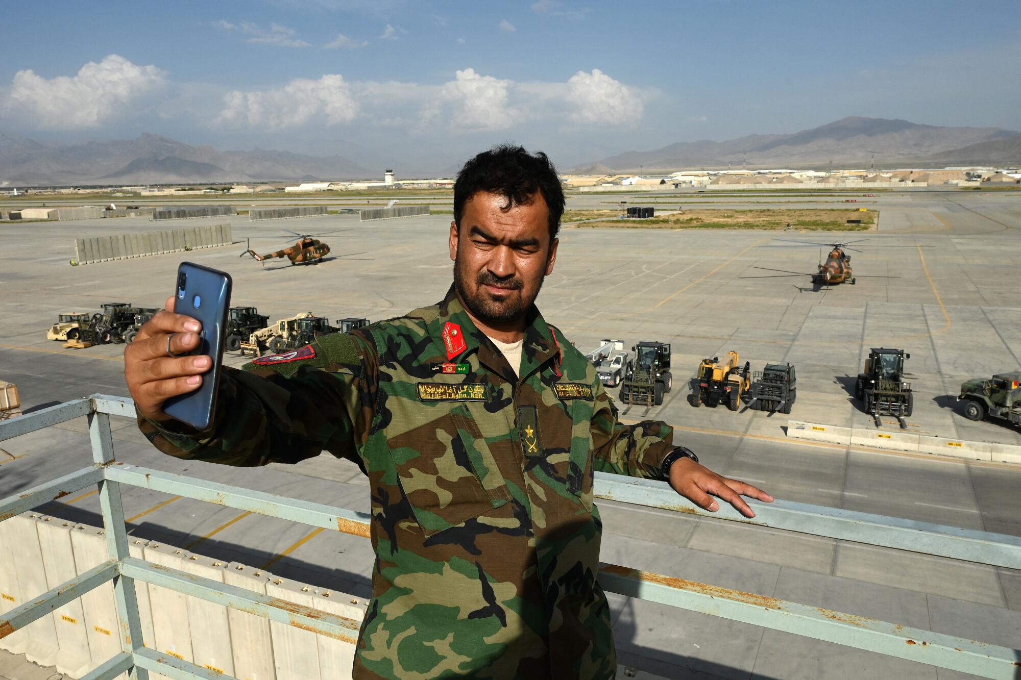 An Afghan soldier takes a selfie at the Bagram base 