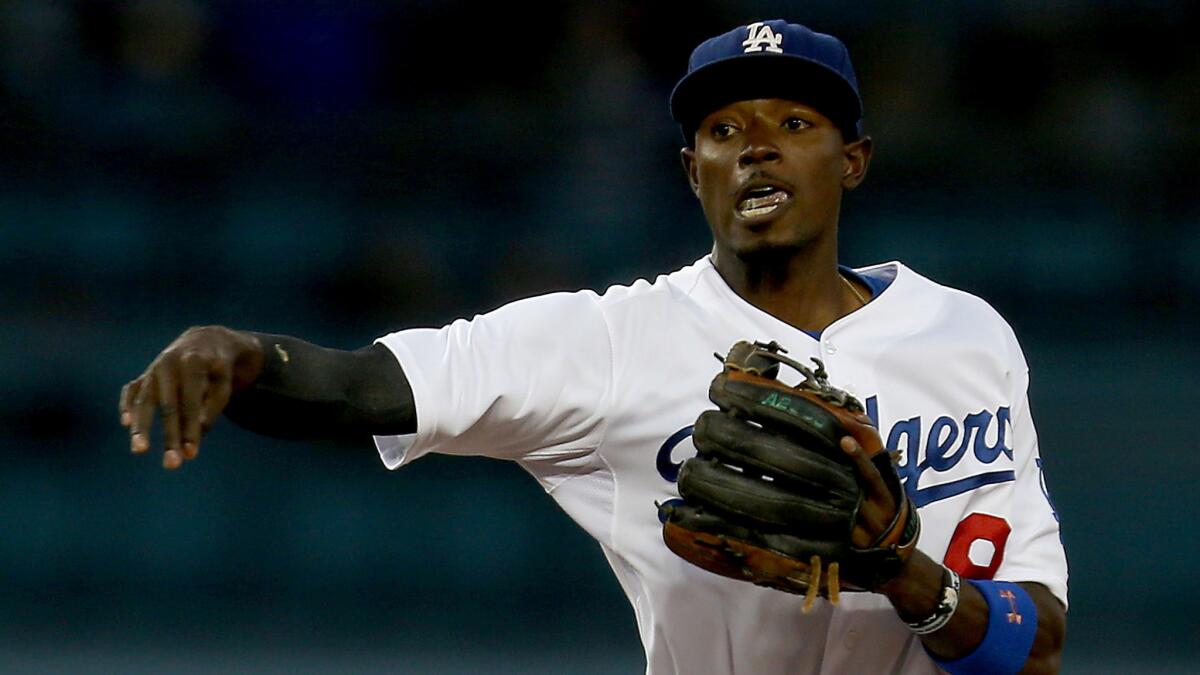 Dodgers second baseman Dee Gordon turns a double play during a game against the San Diego Padres in August.