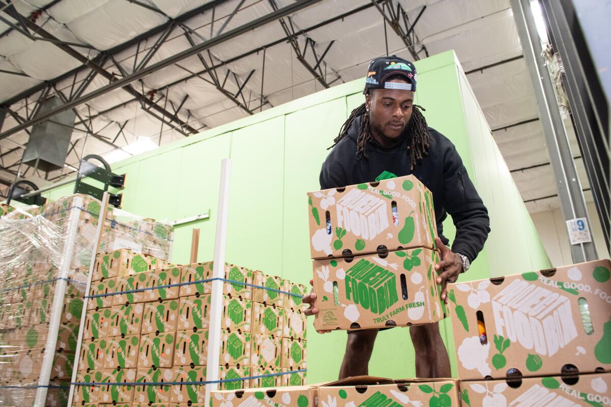 Davante Adams unloads a delivery of fresh product from Project FoodBox at the Three Squares Food Bank in Las Vegas.