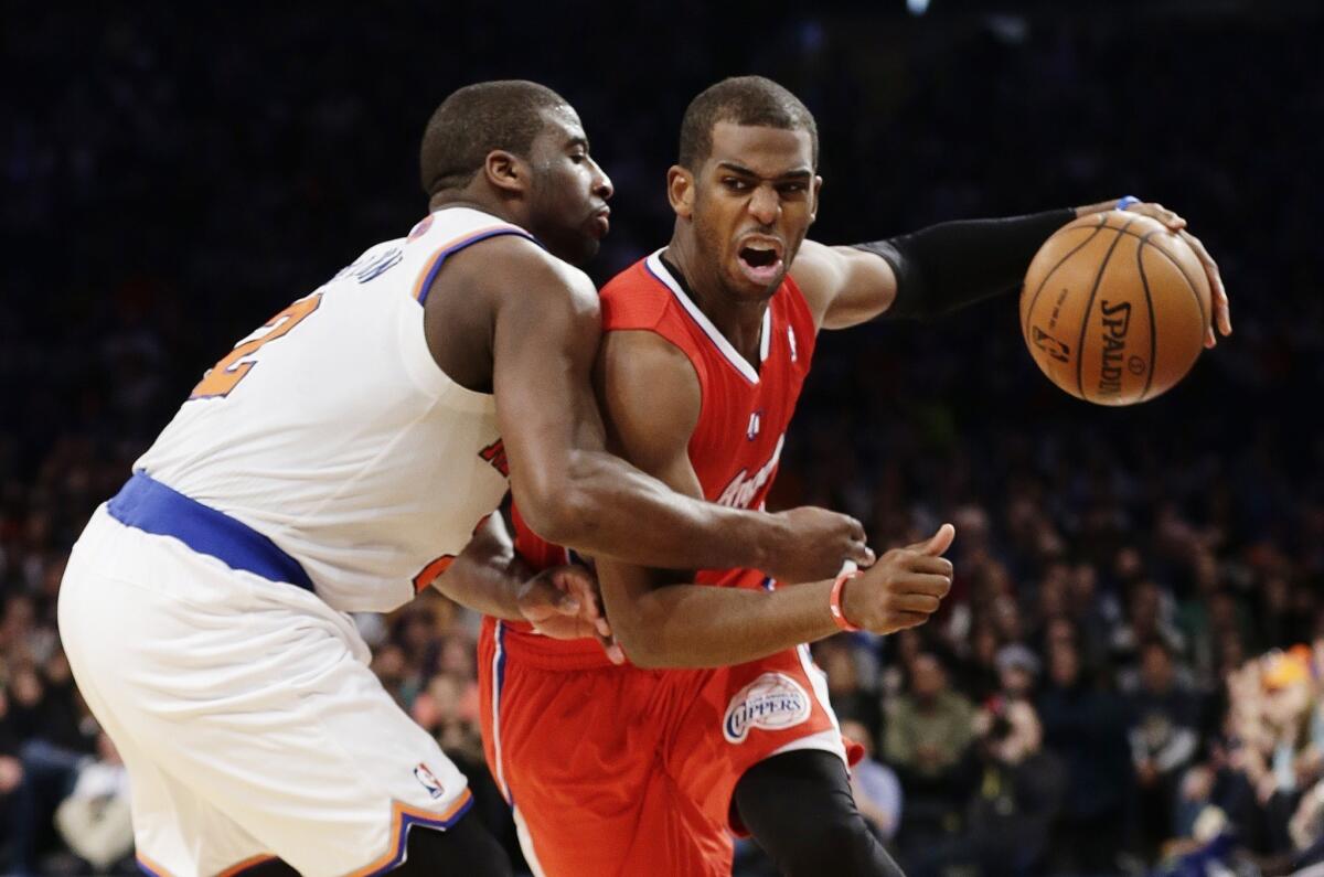Clippers point guard Chris Paul, who finished with 25 points, drives past Knicks point guard Raymond Felton in the second half Sunday.