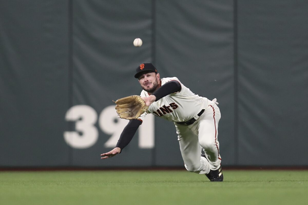 San Francisco Giants center fielder Kris Bryant catches a fly out hit by Los Angeles Dodgers' Trea Turner 