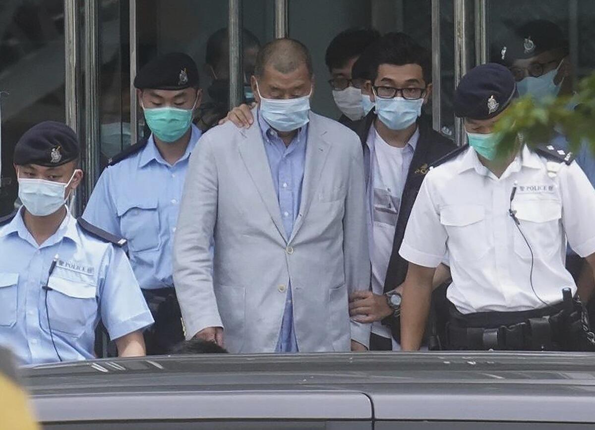 Hong Kong tycoon Jimmy Lai, center, who founded the newspaper Apple Daily, was arrested Aug. 10, 2020.