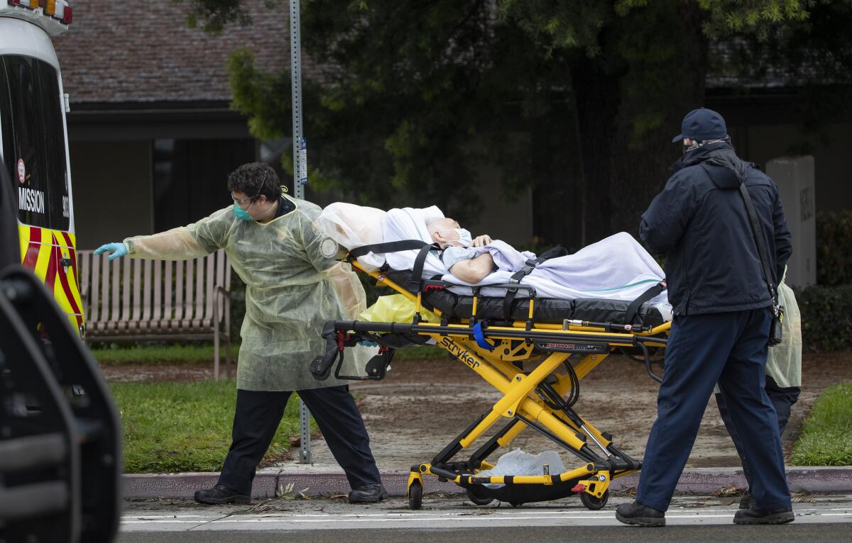 Paramedics load Bernie Erwig, 84, into an ambulance while he was removed from Magnolia Rehabilitation and Nursing Center.