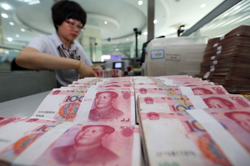 China's central bank on Tuesday devalued its yuan currency by nearly 2% against the U.S. dollar, as authorities seek to push market reforms and bolster the world's second-largest economy.