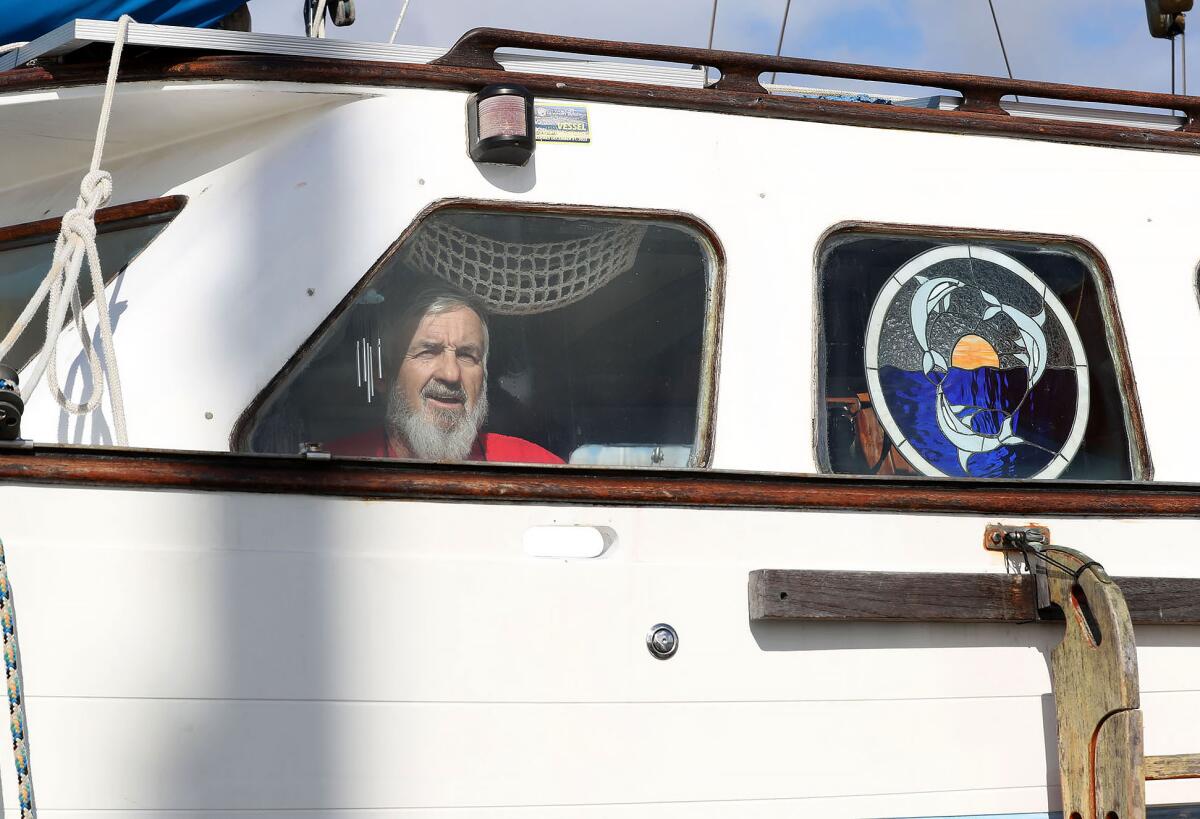 Mike Fleming looks out the window on the port side of his live-aboard vessel in Newport Harbor in Newport Beach.