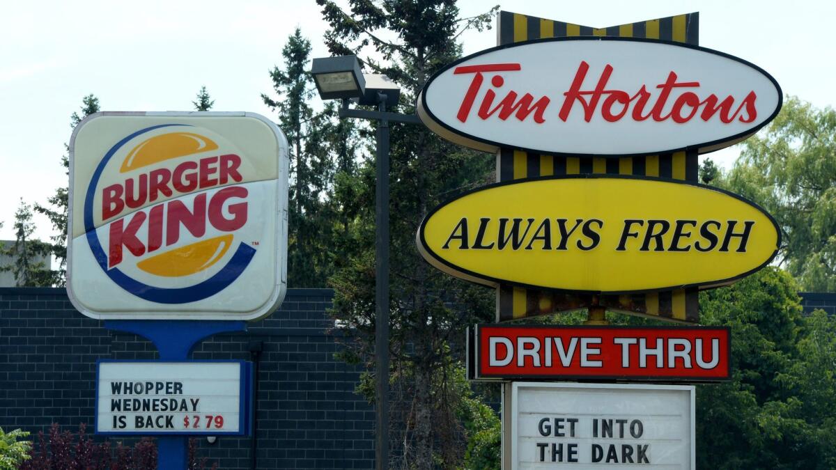 Restaurant Brands International has pledged to limit the use of antibiotics in the chicken it buys for its Burger King and Tim Hortons restaurants.
