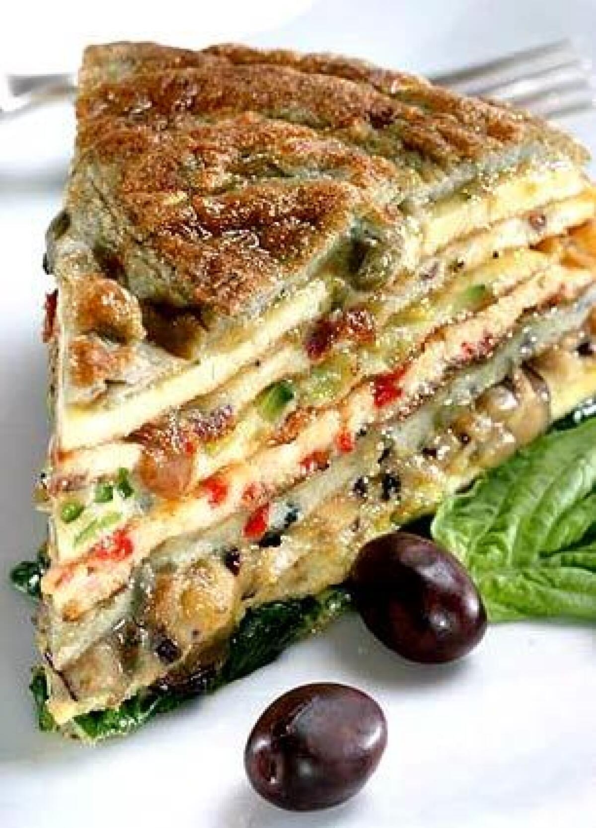Layers of flavored omelets are stacked high and cut into bite-size pieces.