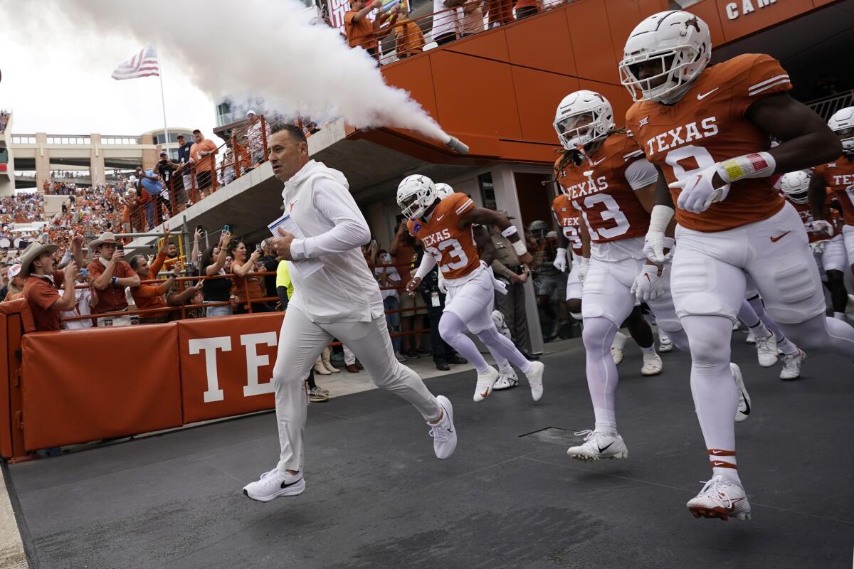 Texas coach Steve Sarkisian leads his players to the field before a game against Kansas State on Nov. 4.