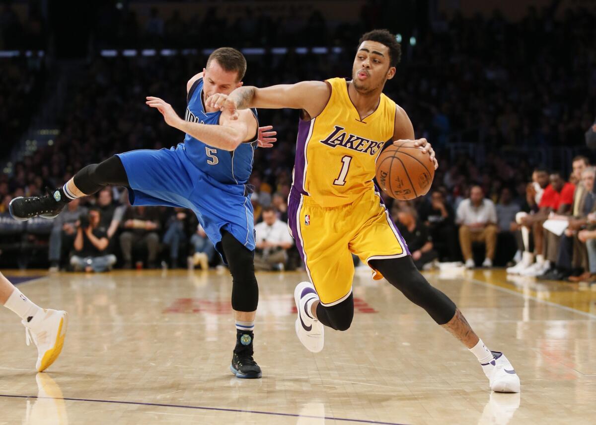 Lakers guard D'Angelo Russell (1) tries to drive around Mavericks guard J.J. Barea during the second half of a game on Jan. 26.