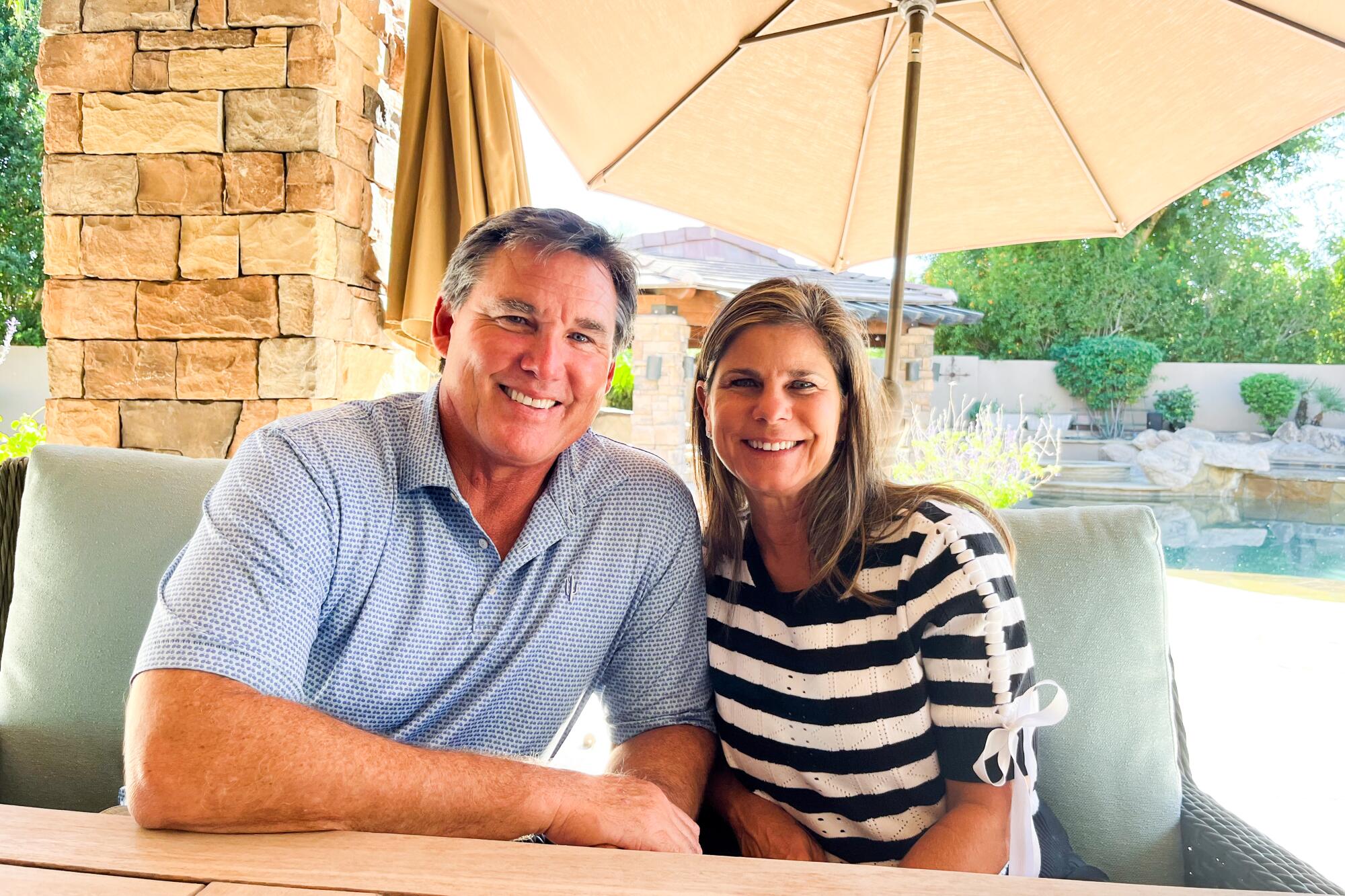 Tim Salmon, left, poses for a photo with his wife Marci Salmon on back patio of their Scottsdale home