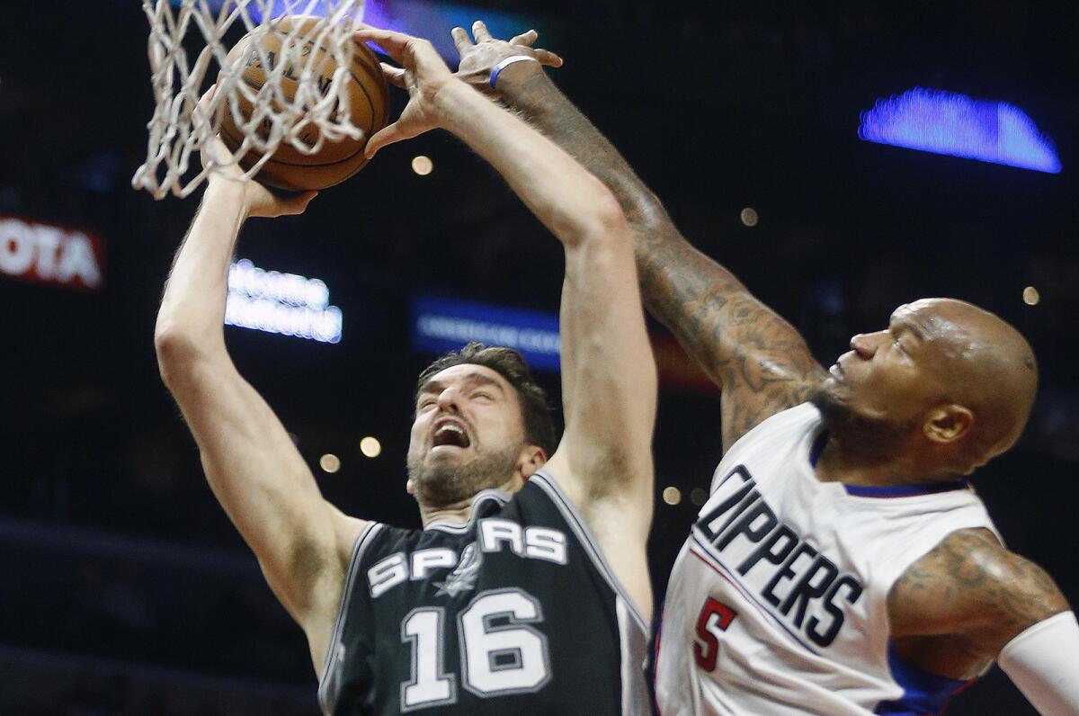 Clippers center Marreese Speights fouls Spurs center Pau Gasol during a game at Staples Center on Dec. 22.