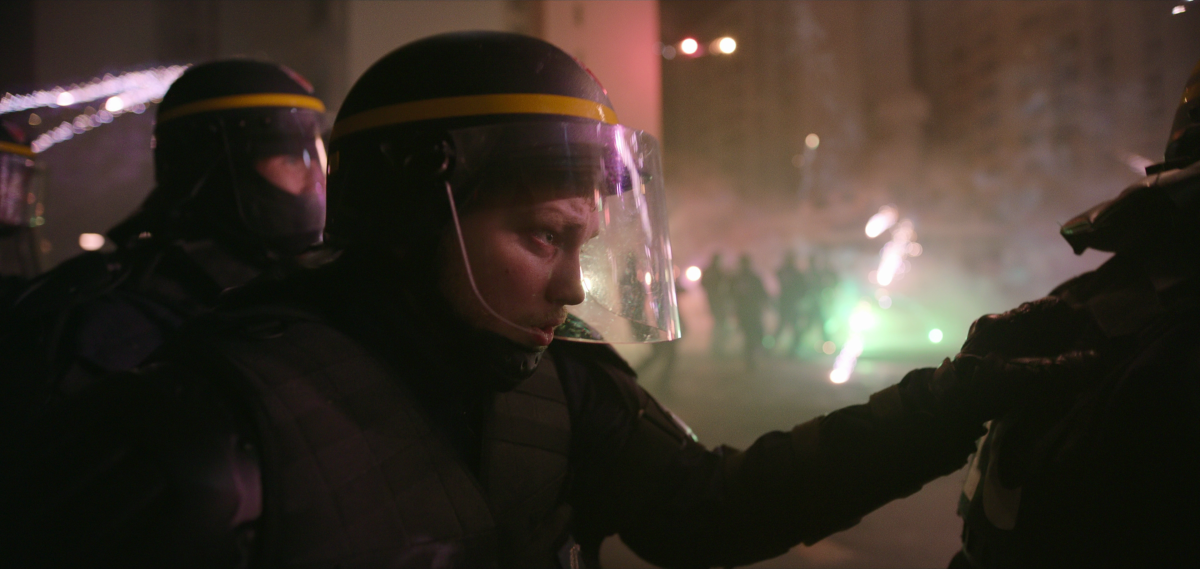 A man in protective police gear.