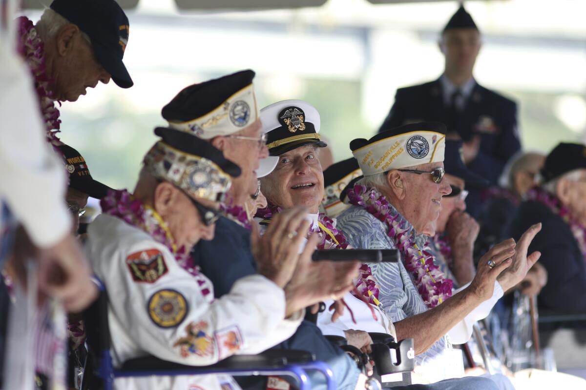 Navy veteran Lou Conter, center, smiles while attending a memorial event at Hawaii's Pearl Harbor in 2019.