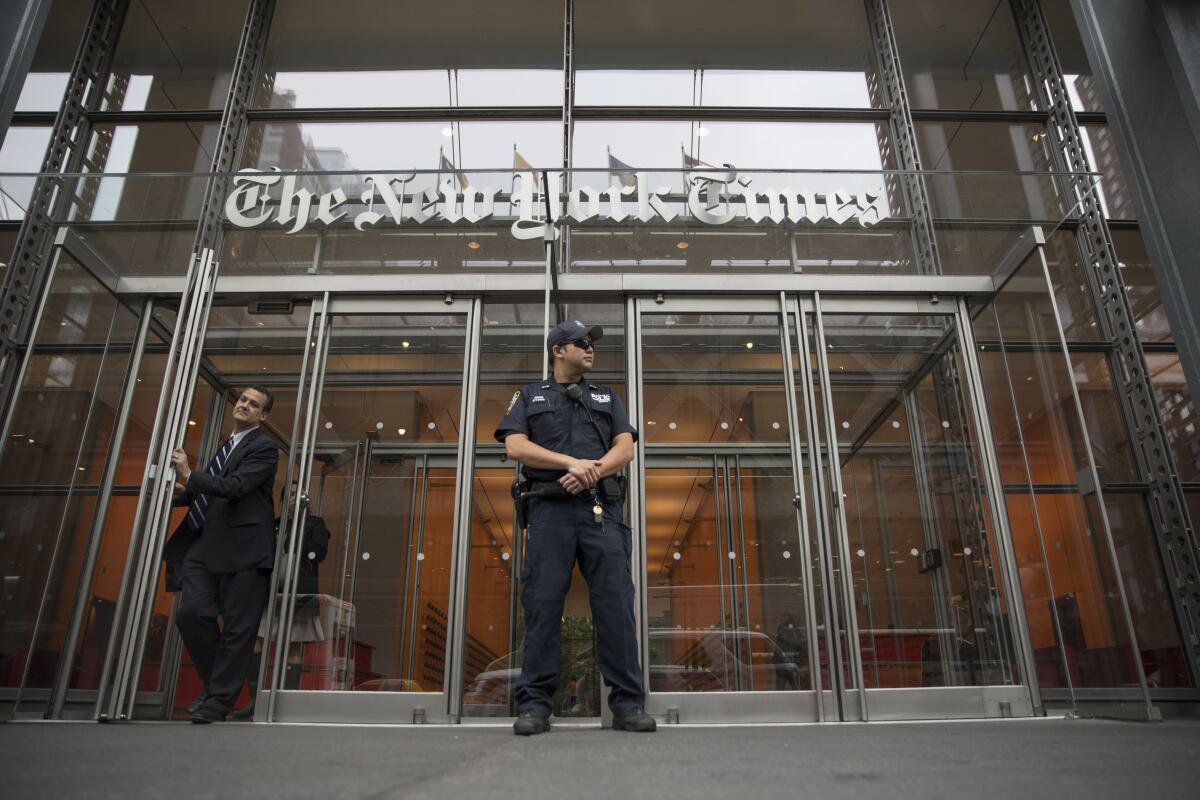 A police officer stands outside the New York Times building