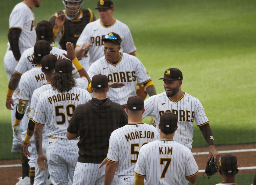 The Padres celebrate their 8-7 victory over the Arizona Diamondbacks on opening day.