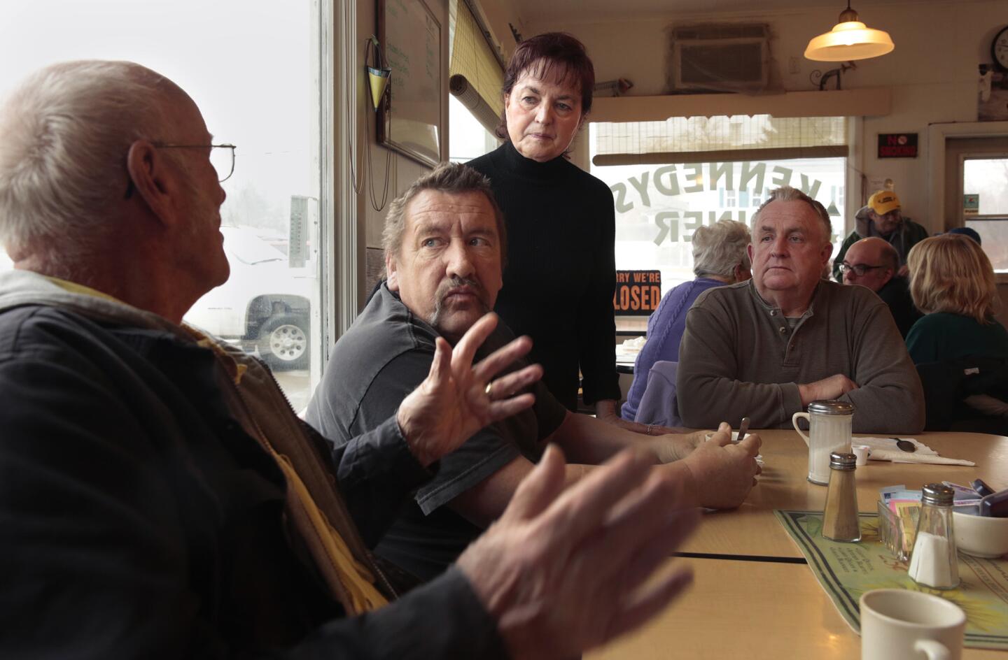 Carolyn Price, the town supervisor of Windsor, N.Y., listens as a resident at Kennedy's Diner discusses the state fracking ban's effect on the local economy.