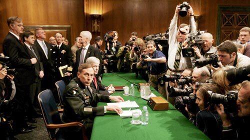 Army Gen. David Petraeus, left, commander of the multinational force in Iraq, and U.S. Ambassador to Iraq Ryan Crocker are surrounded by photographers before the start of a hearing on the war by the Senate Armed Services Committee in Washington.