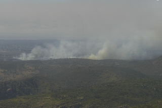 A brush fire burning on Marine Corps Air Station Miramar as seen from Cowles Mountain.