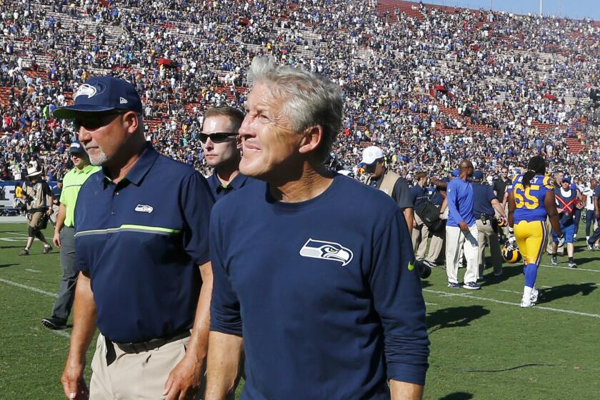 Seahawks Coach Pete Carroll walks off the field after a 9-3 loss to the Rams on Sunday.