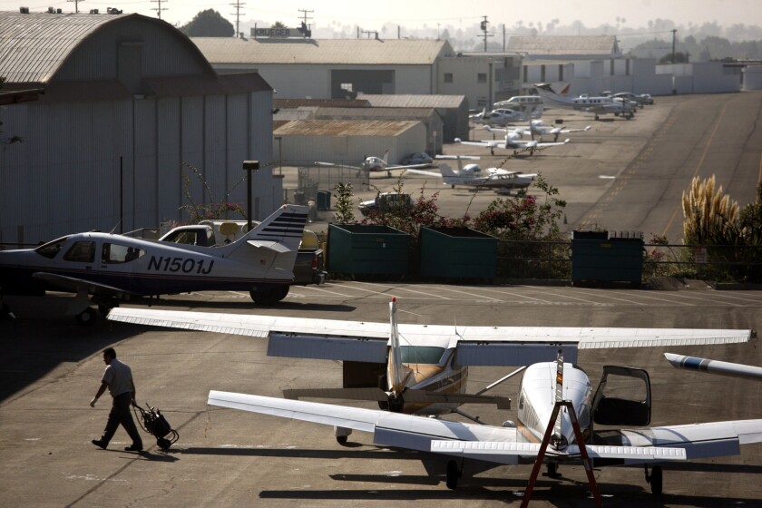 A mechanic walks near planes parked at Santa Monica Airport in 2011.