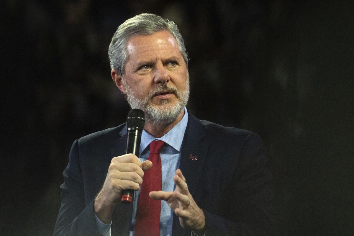 FILE - In this, Nov. 13 2019, file photo, Liberty University President Jerry Falwell Jr. talks to Donald Trump Jr. about his new book "Triggered" during convocation at Liberty University in Lynchburg, Va. Liberty University has filed a civil lawsuit against its former leader, Jerry Falwell Jr., seeking millions in damages after the two parted ways acrimoniously last year. The Associated Press obtained the complaint, which was filed Thursday, April 15, 2021 in Lynchburg Circuit Court. (Emily Elconin/The News & Advance via AP, File)