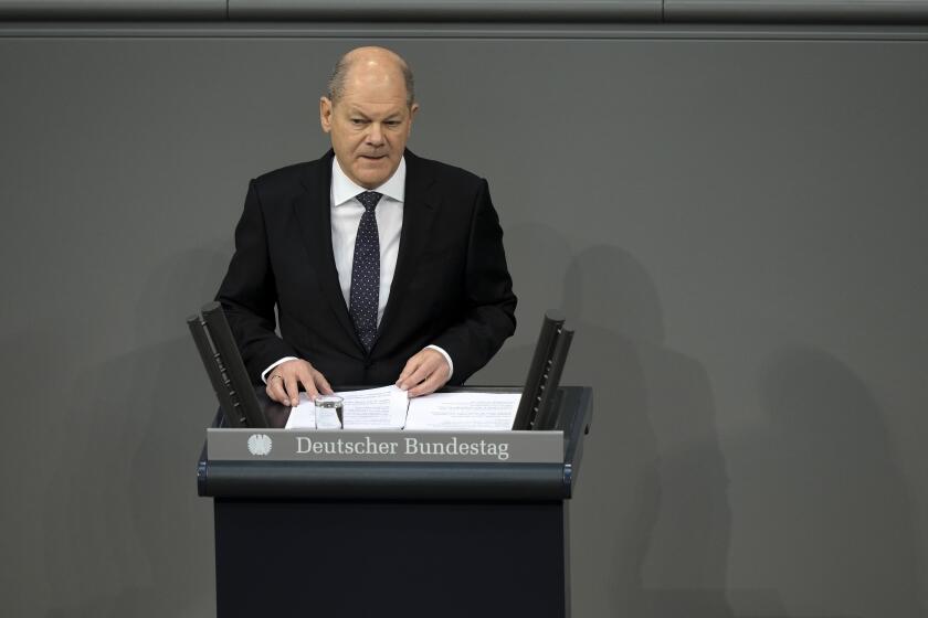 German Chancellor Olaf Scholz delivers a speech about Germany's budget crisis at the parliament Bundestag in Berlin, Germany, Tuesday, Nov. 28, 2023. With its economy already struggling, Germany now is wrestling to find a way out of a budget crisis after a court struck down billions in funding for clean energy projects and help for people facing high energy bills because of Russia's war in Ukraine. (AP Photo/Markus Schreiber)