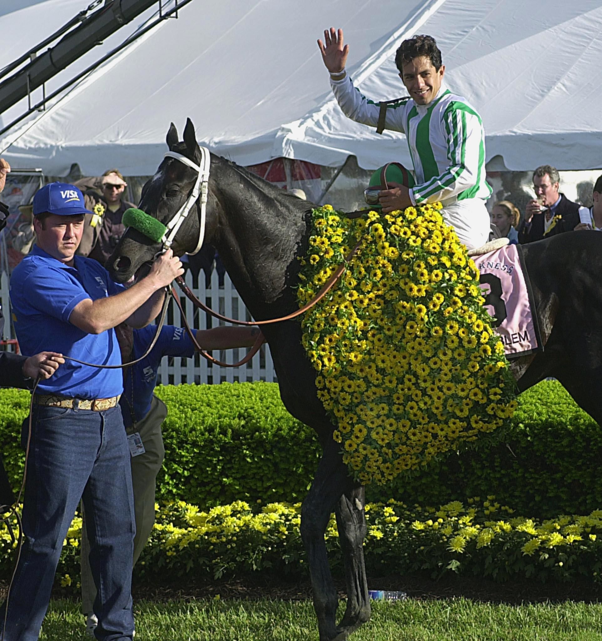  Jockey Victor Espinosa waves in the winners circle after riding War Emblem to victory.