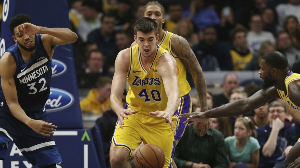 Lakers center Ivica Zubac, trying to chase down a loose ball against Timberwolves center Karl-Anthony Towns, started at forward on Sunday in an unusual lineup that also featured JaVale McGee.