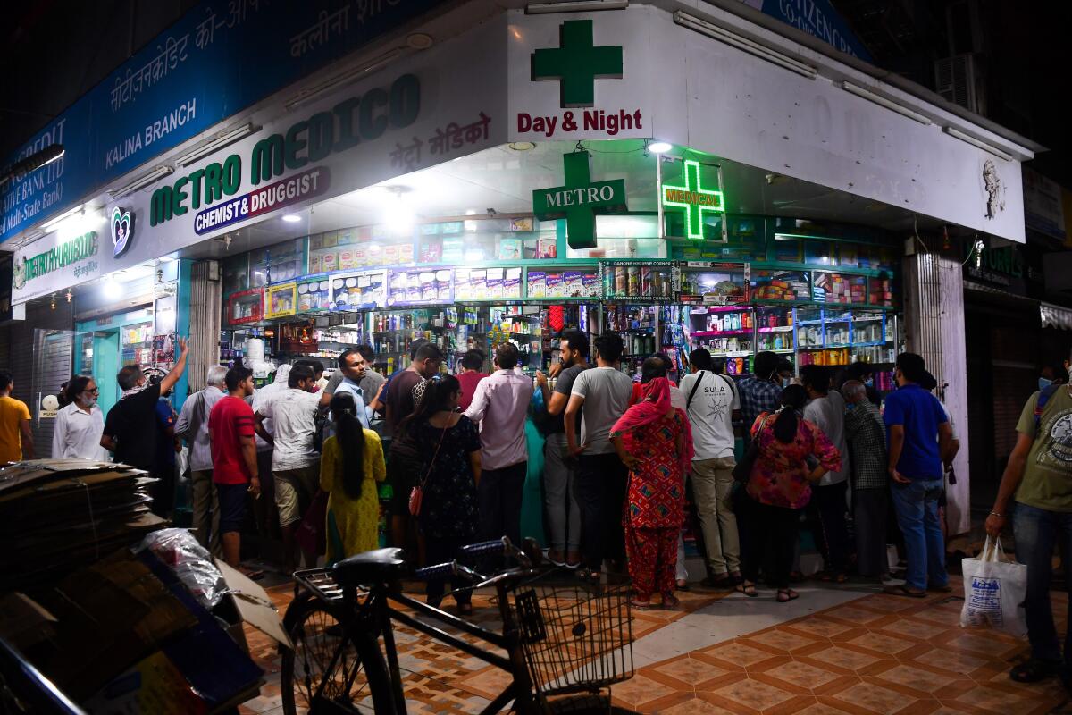 People gather at a pharmacy to buy supplies in Mumbai, India, following Prime Minister Narendra Modi's announcement of a nationwide lockdown on Tuesday.
