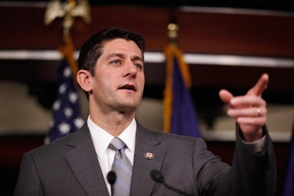 House Budget Committee Chairman Paul Ryan (R-Wis.) takes reporters' questions during a news conference in Washington on Dec. 7, 2011.