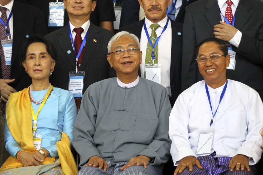 FILE - In this May 24, 2017, file photo, Myanmar's Vice President Myint Swe, right, smiles while sitting with State Counsellor Aung San Suu Kyi, left, and then President Htin Kyaw during a photo session after the second session of the 21st Century Panglong Union Peace Conference at the Myanmar International Convention Center in Naypyitaw, Myanmar. Myanmar military television said Monday, Feb. 1, 2021 that the military was taking control of the country for one year, while reports said many of the country’s senior politicians including Suu Kyi had been detained. The military TV report said Commander-in-Chief Senior Gen. Min Aung Hlaing would be in charge of the country, while Myint Swe would be elevated to acting president. (AP Photo/Aung Shine Oo, File)