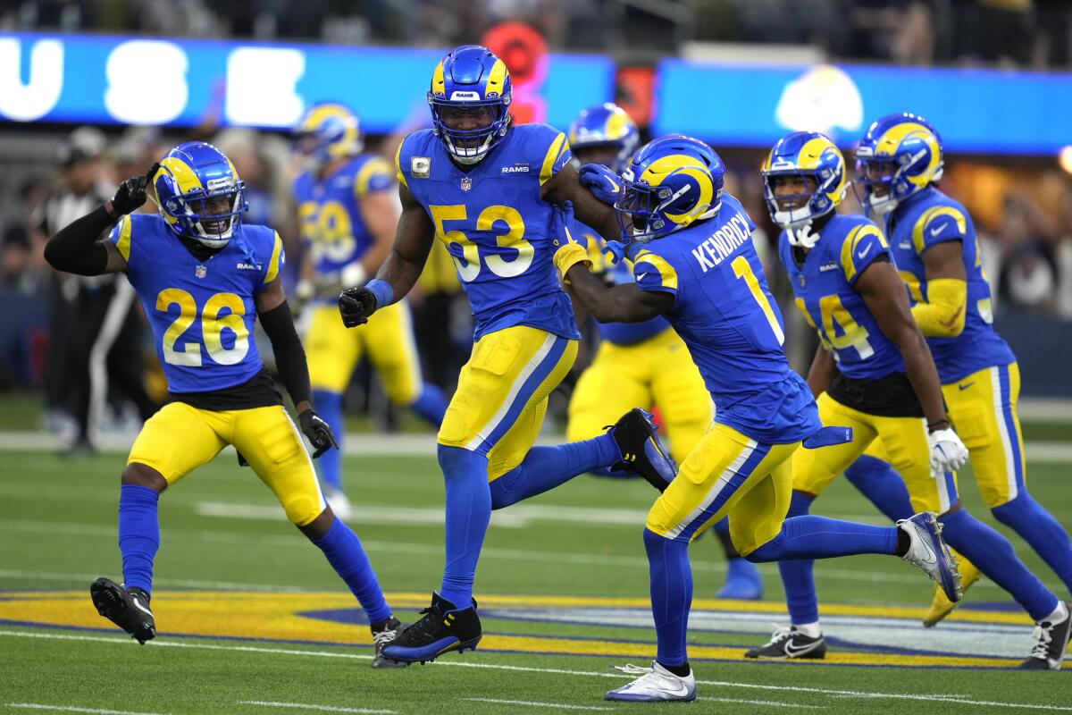 The Rams celebrate after cornerback Derion Kendrick (1) intercepted a Seahawks pass in the fourth quarter.