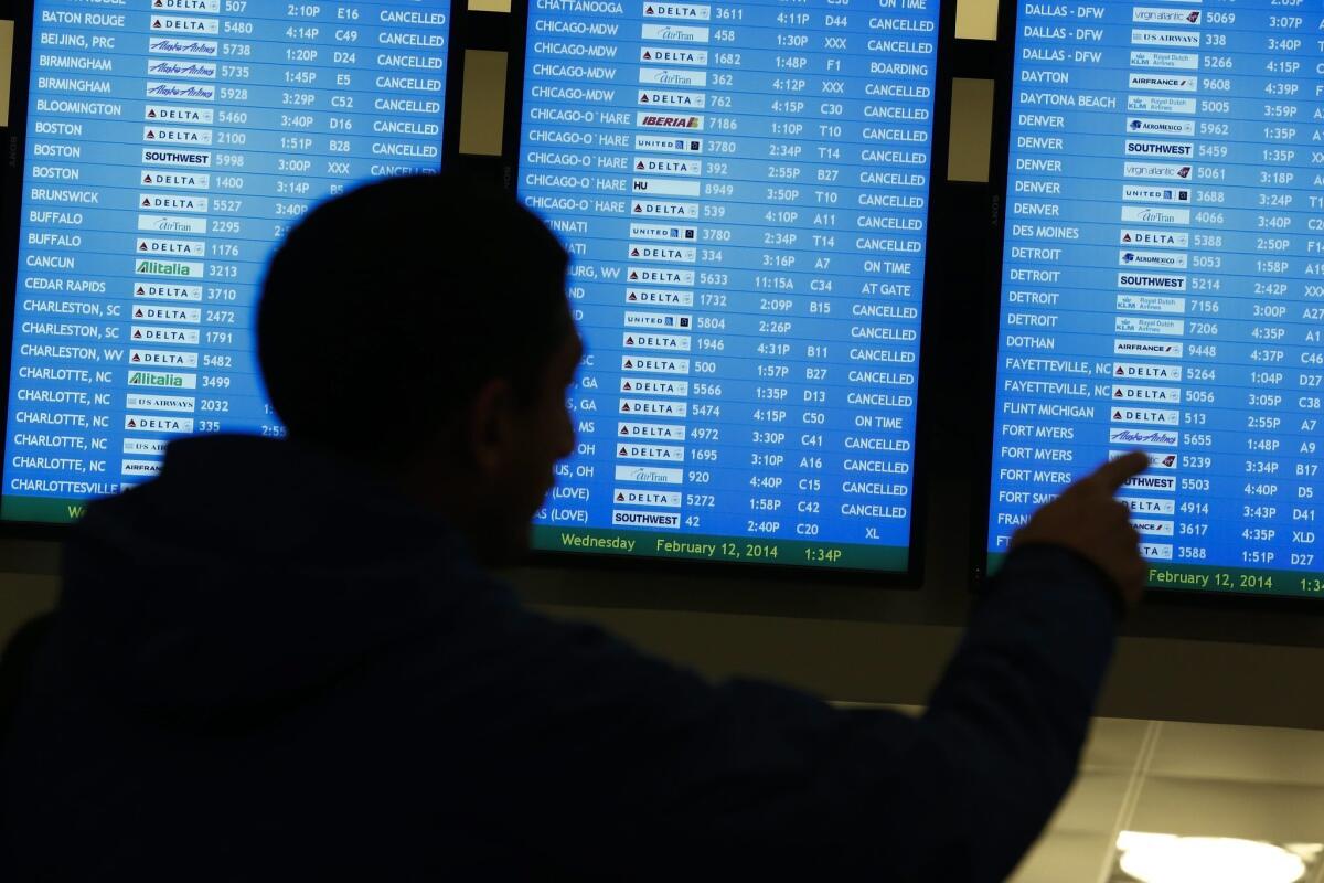 Canceled flights are seen on a video display at Hartsfield-Jackson Atlanta International Airport during a severe winter storm Wednesday.