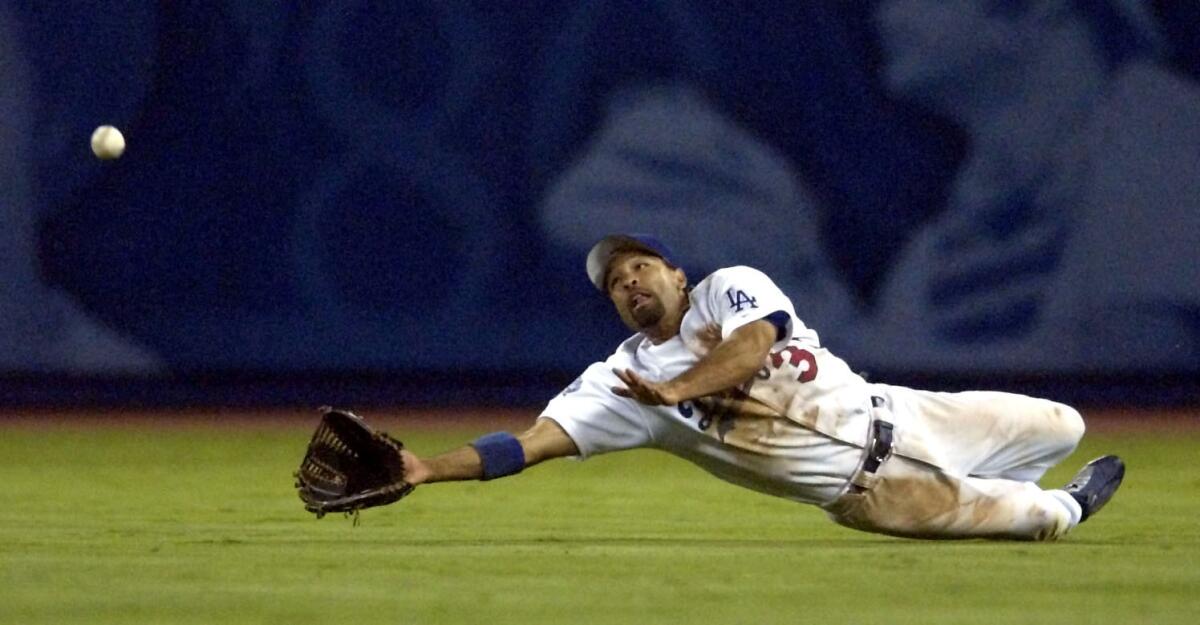 Dodger centerfielder Dave Roberts makes the catch on a ball hit by St. Louis' Tino Martinez in 2002.