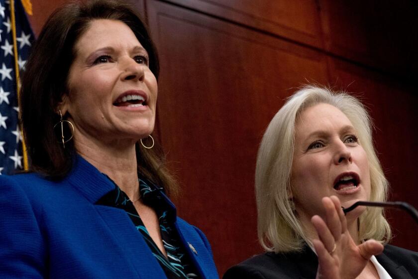 Rep. Cheri Bustos, D-Ill., left, and Sen. Kirsten Gillibrand, D-N.Y., right, speak at a news conference where members of congress have introduced legislation to curb sexual harassment in the workplace, on Capitol Hill, Wednesday, Dec. 6, 2017, in Washington. Gillibrand and fellow female Democratic senators have united in calling for Sen. Al Franken to resign amid sexual misconduct allegations. (AP Photo/Andrew Harnik)