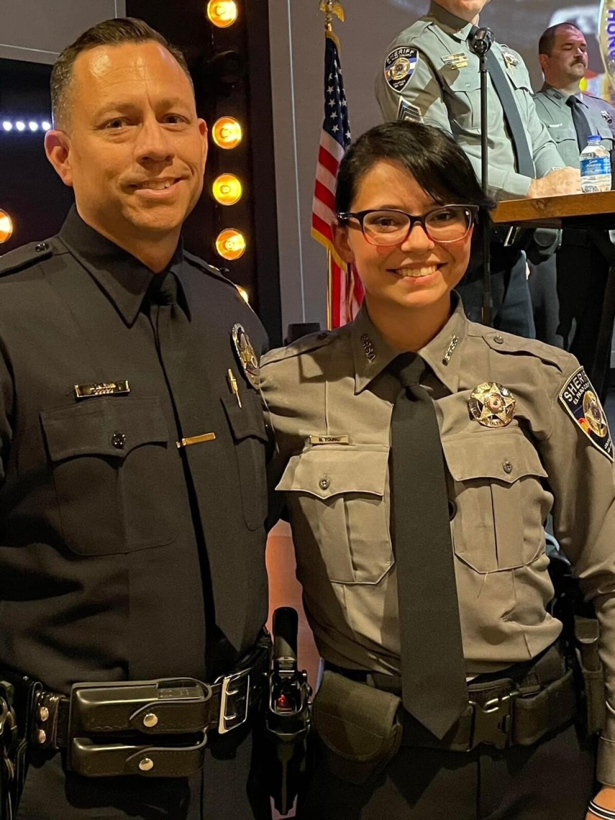 Escondido Police Sgt. Jeff Valdivia smiles with new El Paso County Sheriff's Deputy Natalie Young.