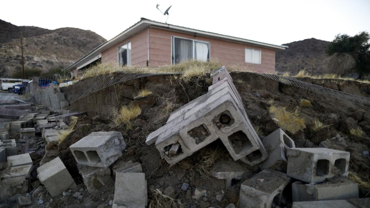 Cinder blocks from a toppled wall are scattered outside a home in Trona, Calif., deemed uninhabitable because of structural damage from the magnitude 7.1 earthquake on Friday.