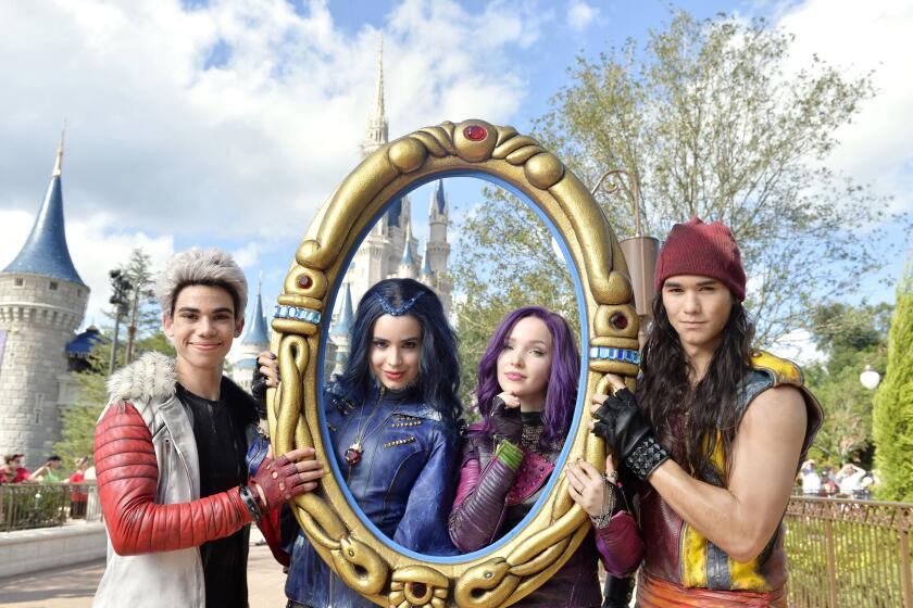 LAKE BUENA VISTA, FL - NOVEMBER 10: In this handout provided by Disney Parks, The cast of Disney Channel Original Movie 'Descendants' (L-R) Cameron Boyce who plays Carlos, Sofia Carson who plays Evie, Dove Cameron who plays Mal and Booboo Stewart who plays Jay pose during a break from taping the Disney Parks Unforgettable Christmas Celebration TV special in Magic Kingdom park at Walt Disney World Resort November 10, 2015 in Lake Buena Vista, Florida. The 32nd annual holiday telecast airs nationwide Dec. 25 on ABC-TV. (Photo by Mariah Wild/Disney Parks via Getty Images)