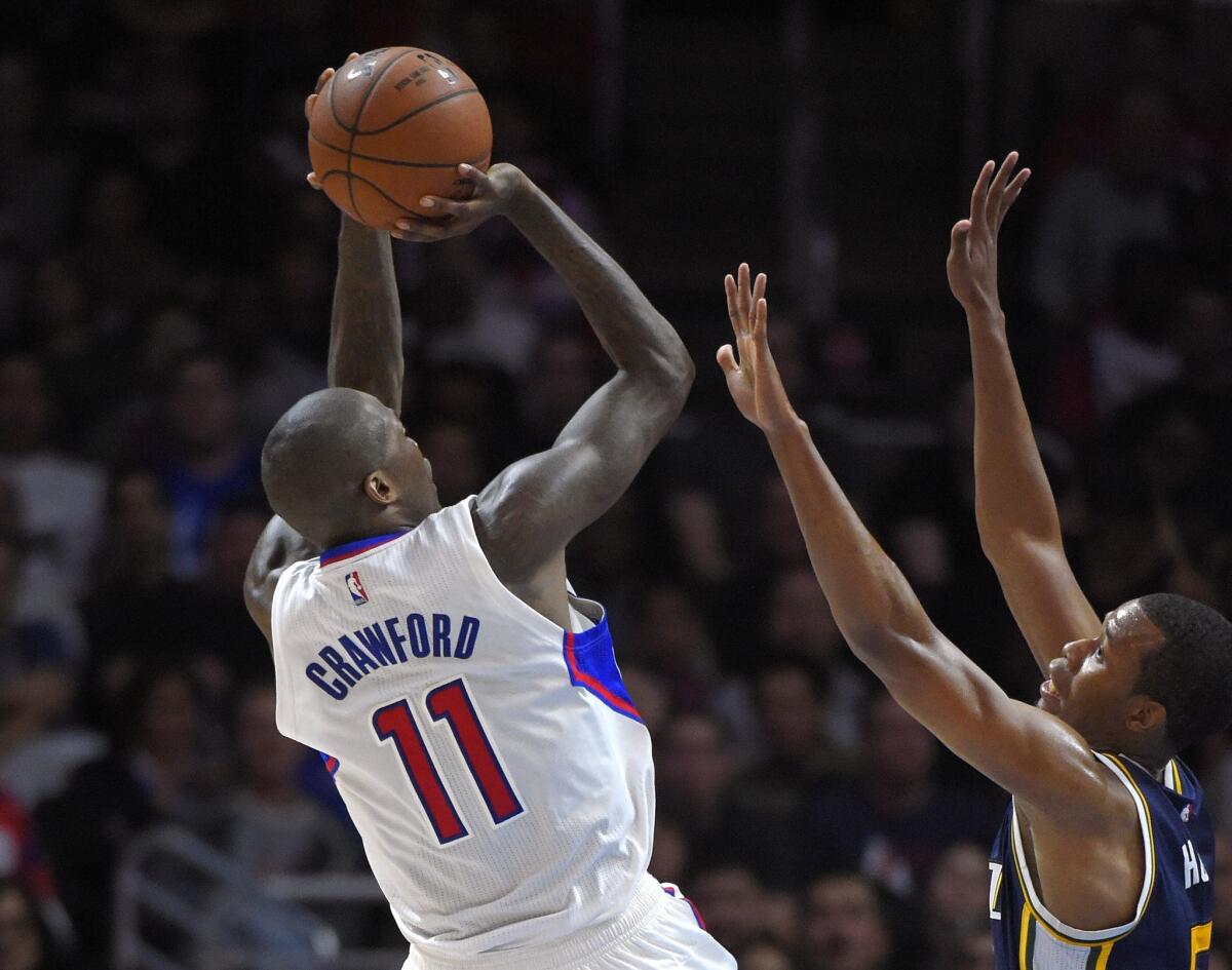 Jamal Crawford puts up a shot over Utah's Rodney Hood during the second half of a game on Nov. 3. The Clippers beat the Jazz, 107-101.