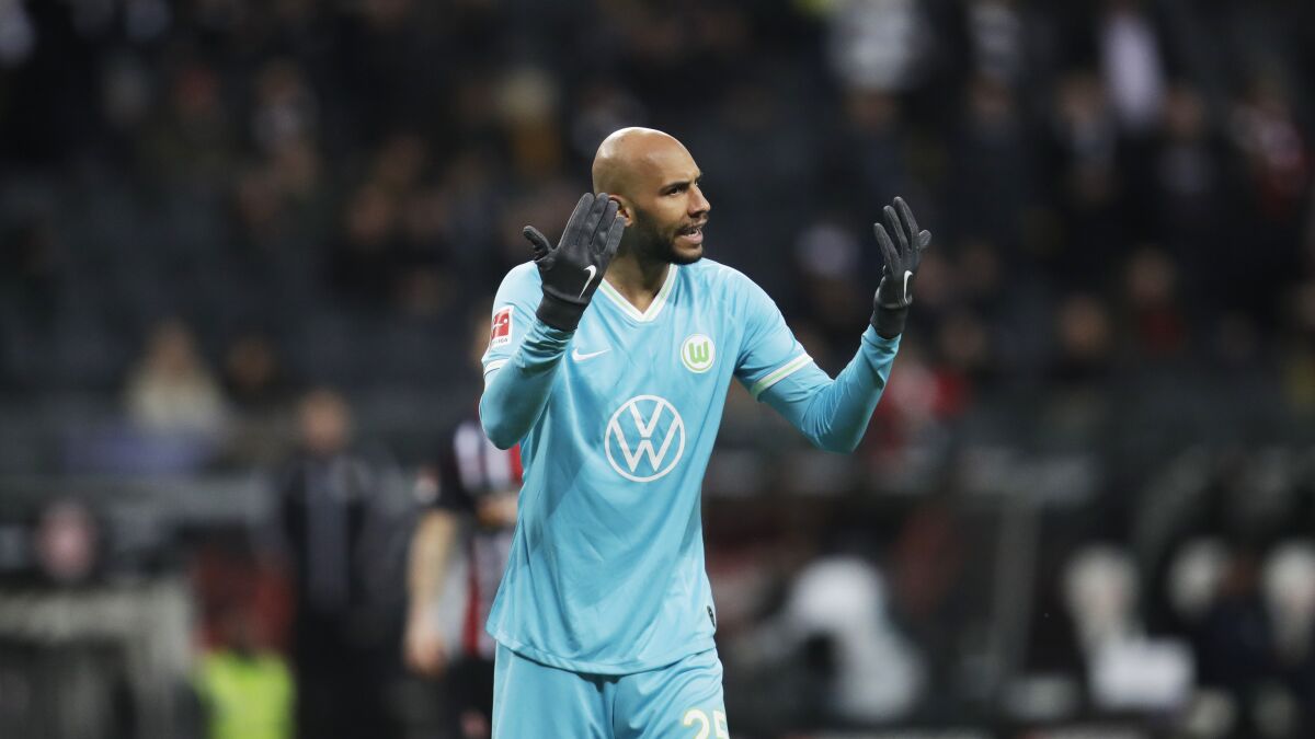 Wolfsburg's player John Brooks from the United States, gestures during the German Bundesliga soccer match between Eintracht Frankfurt and VfL Wolfsburg in the Commerzbank Arena Frankfurt, Germany In this Saturday, Nov. 23, 2019. Wolfsburg is benefitting from American input after making a club-record 10-game unbeaten start to the Bundesliga. (AP Photo/Michael Probst)