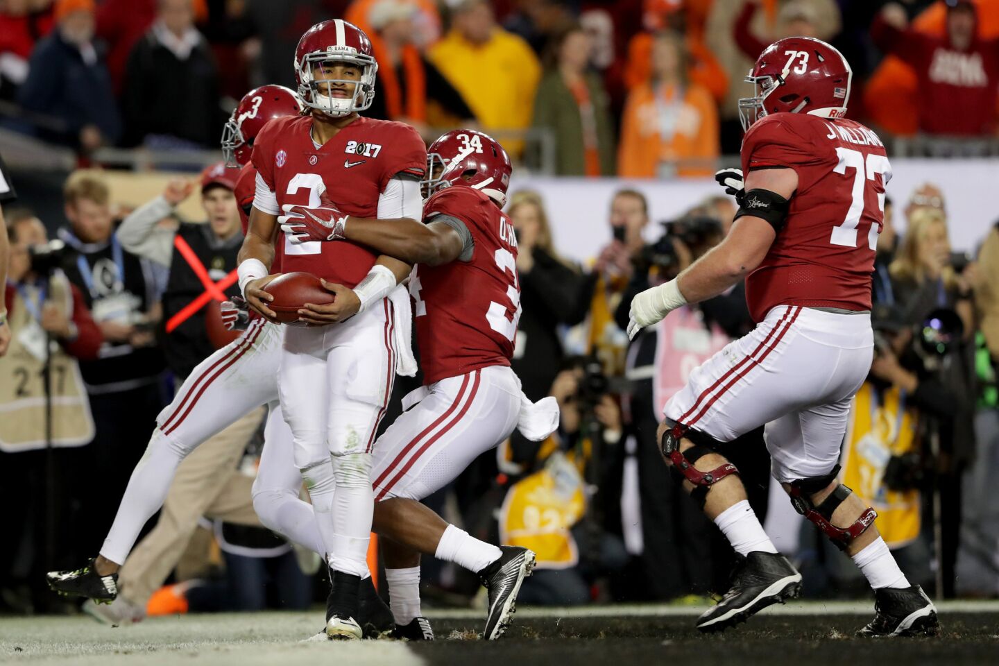 Alabama quarterback Jalen Hurts (2) celebrates with teammates after rushing for a 30-yard touchdown during the fourth quarter.