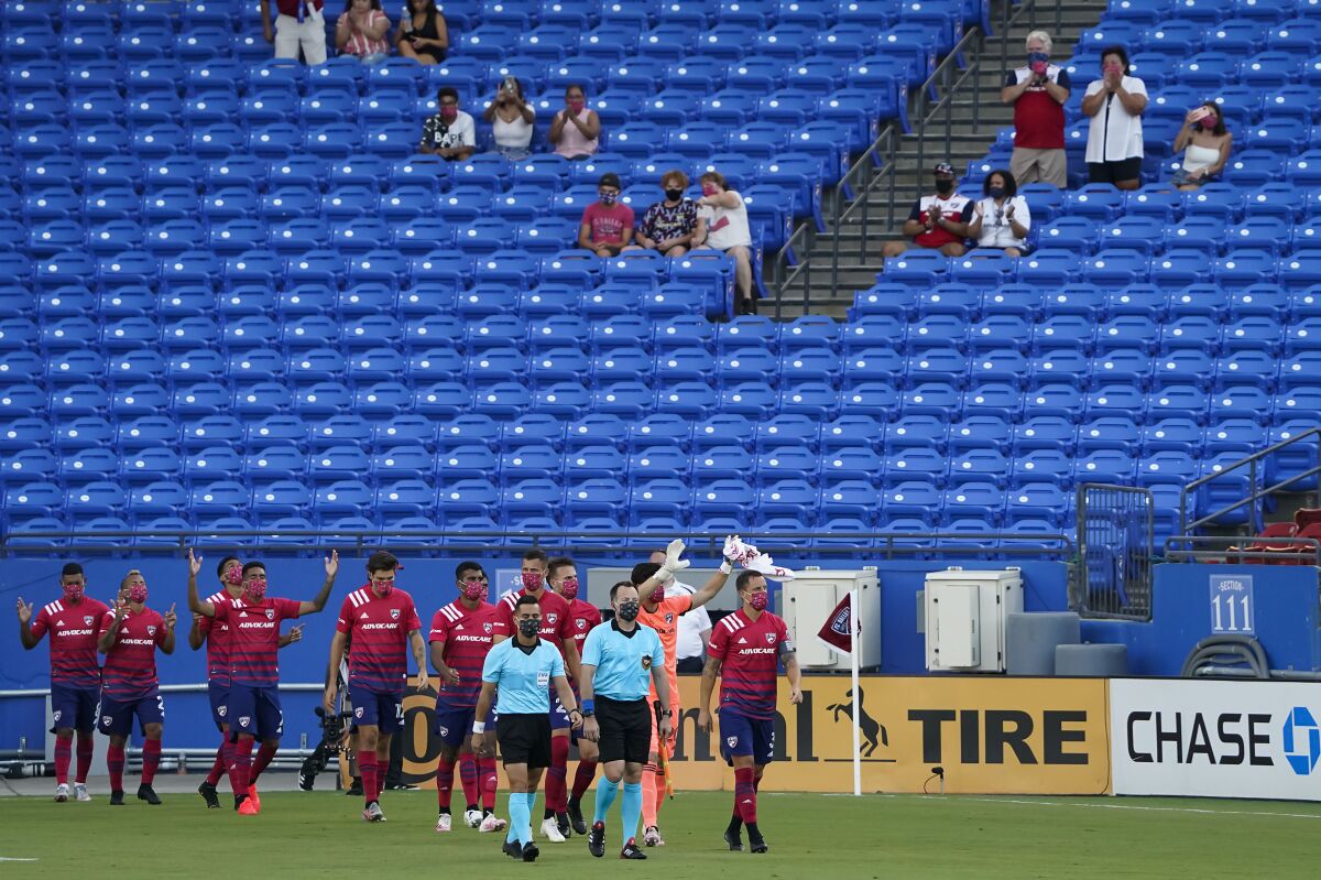 FC Dallas player acknowledges supporters as they take the field before an MLS soccer game against the Nashville SC at Toyota Stadium on Wednesday, Aug. 12, 2020, in Frisco, Texas. (Smiley N. Pool/The Dallas Morning News via AP)