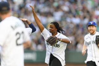 Former professional softball player and Olympian Natasha Watley smiles after catching a fly ball.
