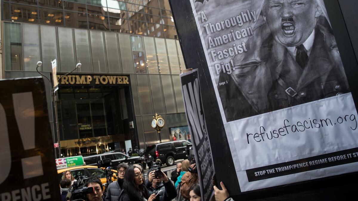 A small group of Donald Trump critics rallies across the street from Trump Tower.