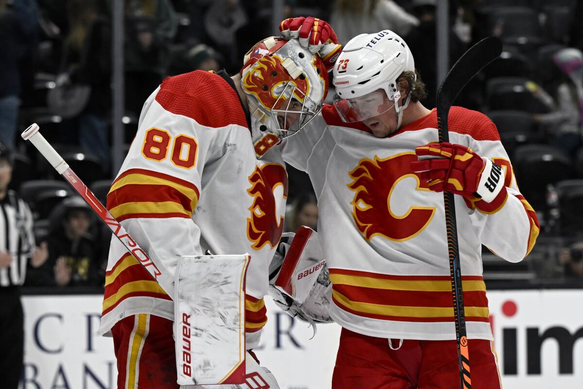 Calgary Flames right wing Tyler Toffoli (73) celebrates with goaltender Dan Vladar (80) after the Flames defeated the Anaheim Ducks in an NHL hockey game in Anaheim, Calif., Tuesday, March 21, 2023. (AP Photo/Alex Gallardo)