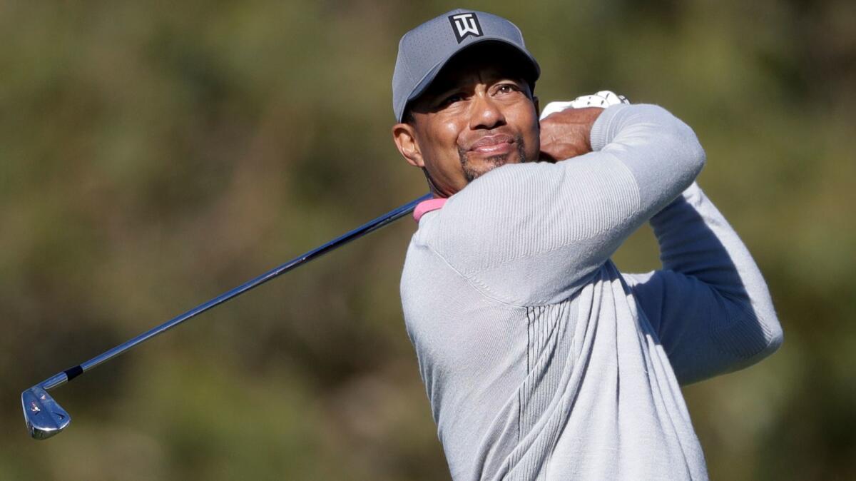 Tiger Woods watches a tee shot during the Farmers Insurance Open at Torrey Pines Golf Course near San Diego on Jan. 27.