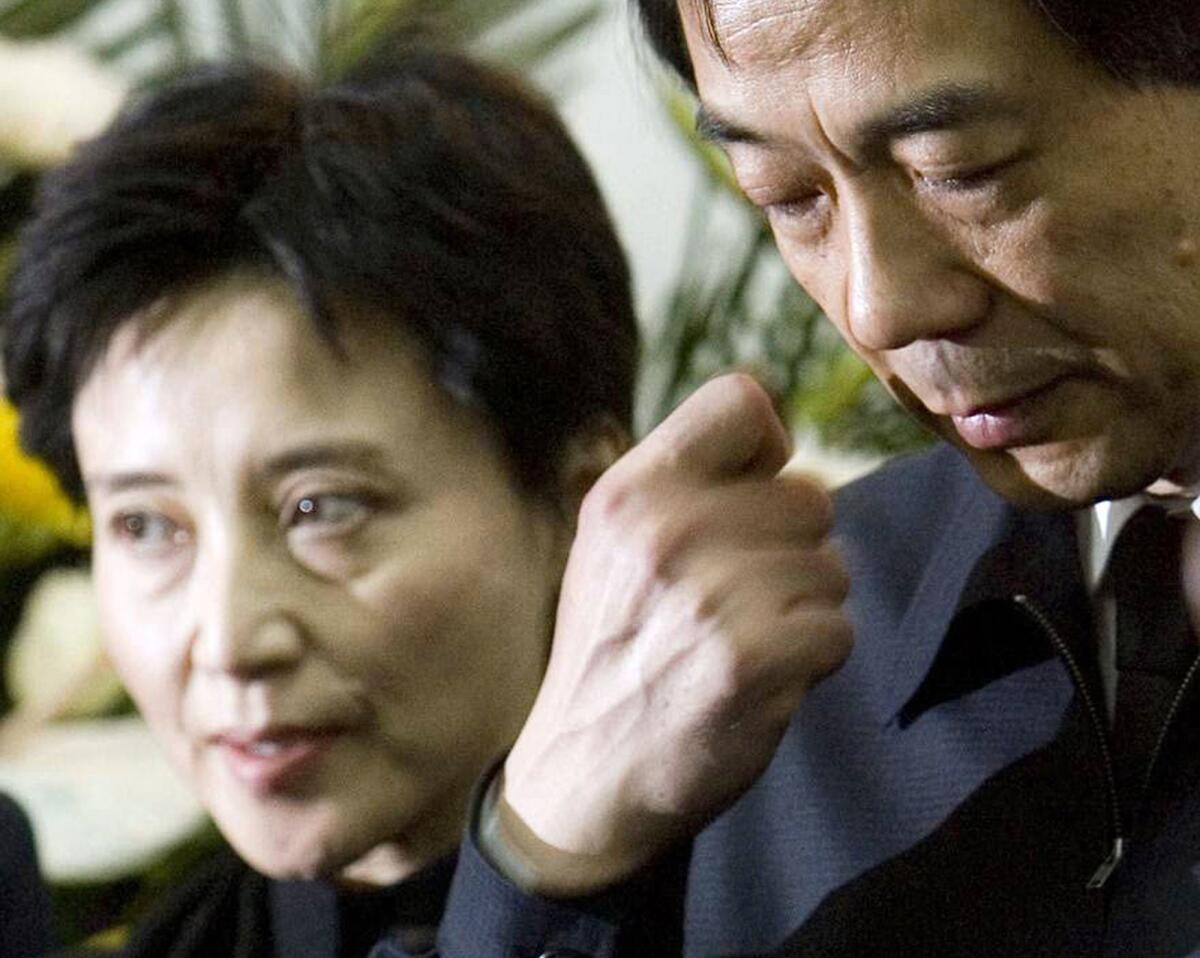 In this 2007 file photo, Bo Xilai, right, and his wife, Gu Kailai, attend a memorial ceremony for Bo's father, Bo Yibo, a revolutionary leader considered one of communist China's founding fathers, at a military hospital in Beijing.