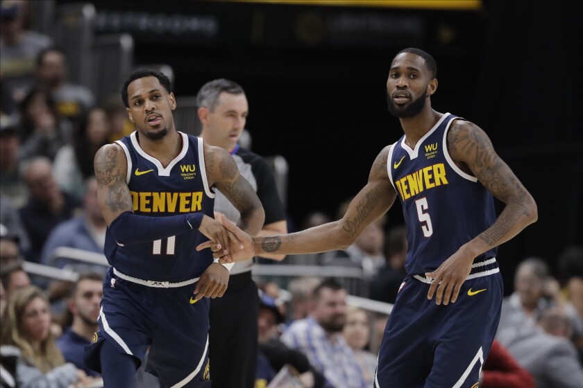 FILE - Denver Nuggets' Monte Morris (11) and Will Barton (5) react during the second half of an NBA basketball game against the Indiana Pacers, Thursday, Jan. 2, 2020, in Indianapolis. The Nuggets have agreed to a deal that would send guards Will Barton and Monte Morris to the Washington Wizards for Kentavious Caldwell-Pope and Ish Smith, a person with knowledge of the negotiations said Wednesday, June 29, 2022. (AP Photo/Darron Cummings, File)